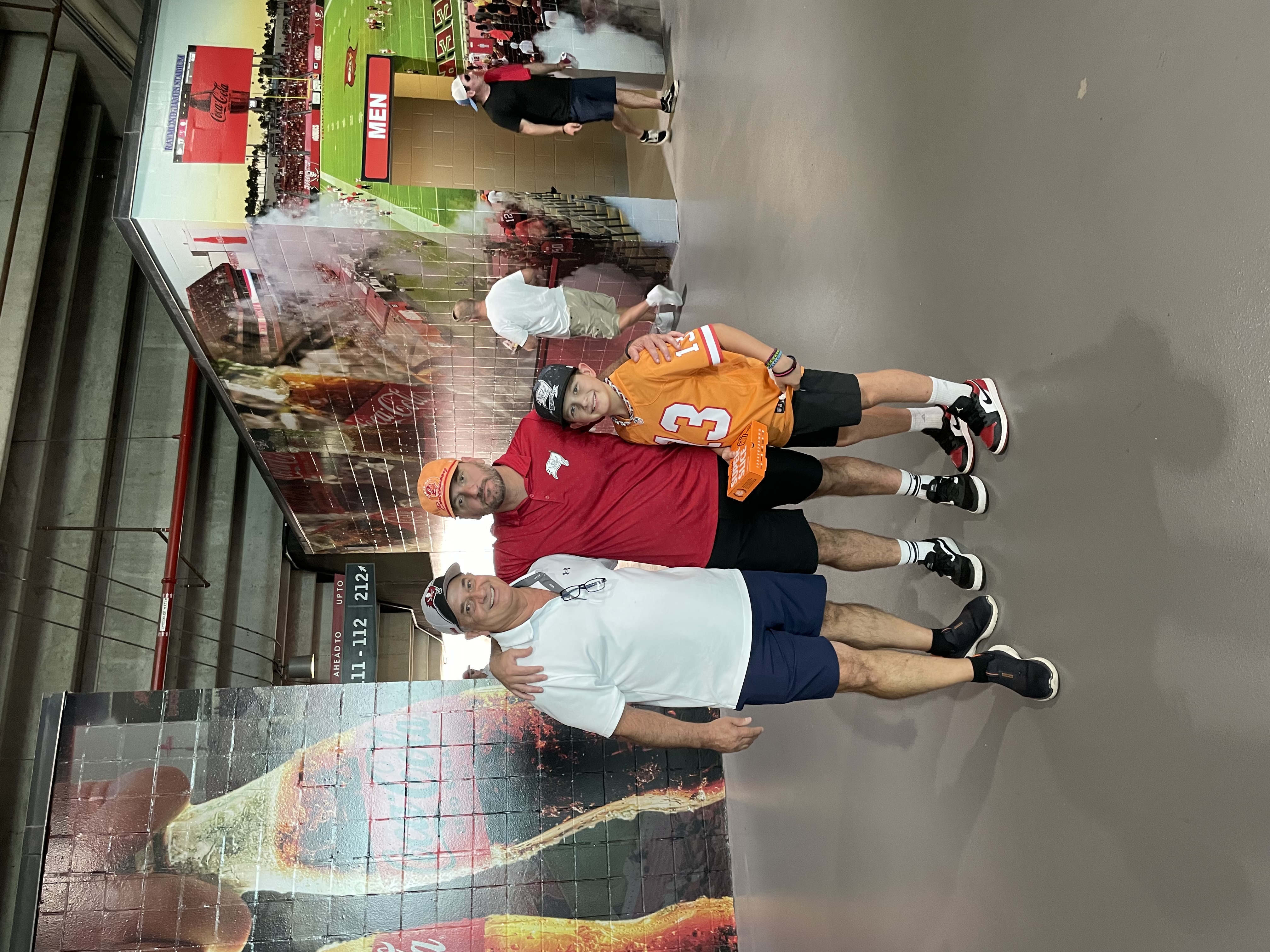 Papa Muñoz with his son and grandson at Raymond James Stadium
